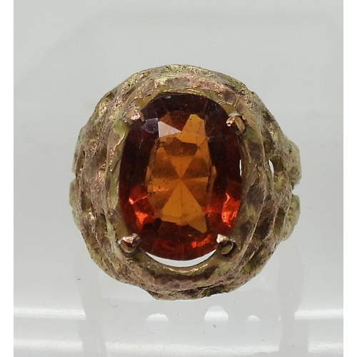 774 - A yellow metal retro ring set with an orange gem stone, size J, weight 6.1gms 