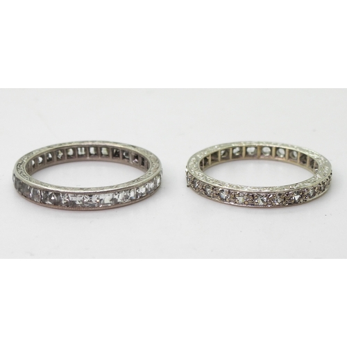 777 - A 9ct white gold clear gem set eternity ring, size O1/2, together  with a similar white metal e... 