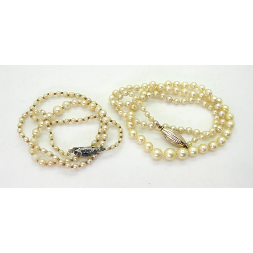 795 - Two strings of cultured pearls, one with a bi colour clasp, length 53cm