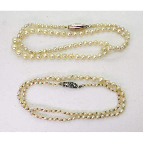 795 - Two strings of cultured pearls, one with a bi colour clasp, length 53cm