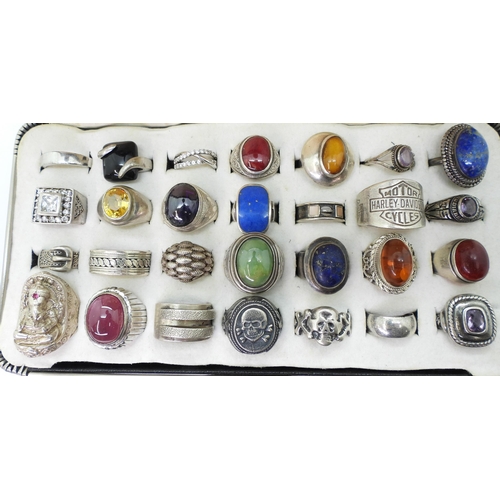 883 - Twenty eight silver and white metal rings, to include lapis lazuli, amber, a ring in the shape of Ga... 