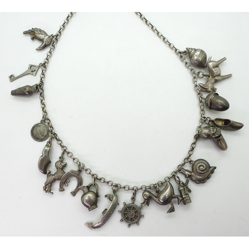 885 - A traditional Dutch silver charm necklace, with eighteen silver and white metal attached charms