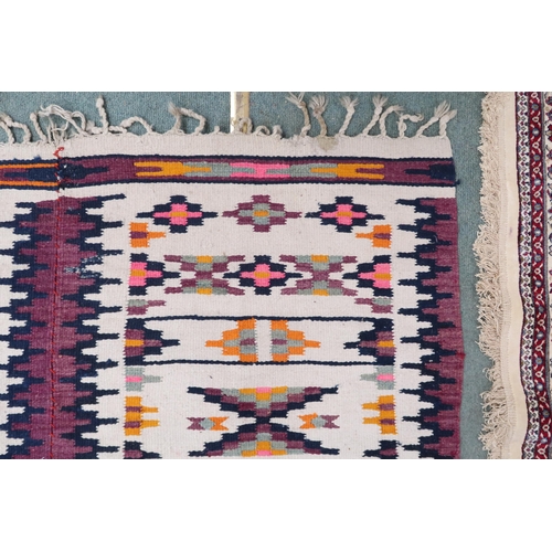 57 - A cream ground Navajo style rug with all over geometric design, 209cm long x 151cm wide