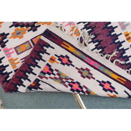 57 - A cream ground Navajo style rug with all over geometric design, 209cm long x 151cm wide