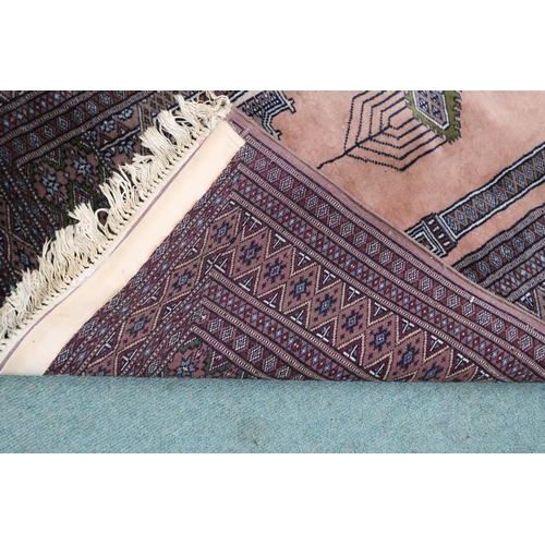 81 - A pink ground Persian style prayer rug with multicoloured borders, 150cm long x 99cm wide 