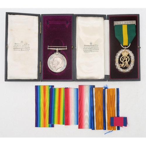 438 - A George V Territorial Decoration by Garrard and Co. and WW1 Defence Medal awarded to Capt. G.H.H. E... 