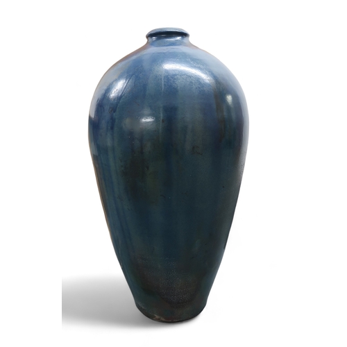 2323 - ALICE MACFARLANEAn oversized studio pottery vase of shouldered tapering form, in blue glaze, 95cm hi... 