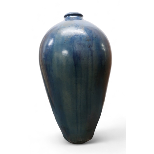 2323 - ALICE MACFARLANEAn oversized studio pottery vase of shouldered tapering form, in blue glaze, 95cm hi... 