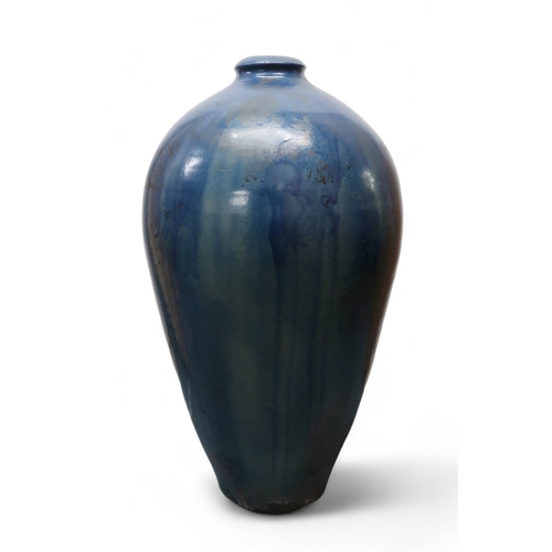 2323 - ALICE MACFARLANEAn oversized studio pottery vase of shouldered tapering form, in blue glaze, 95cm hi... 