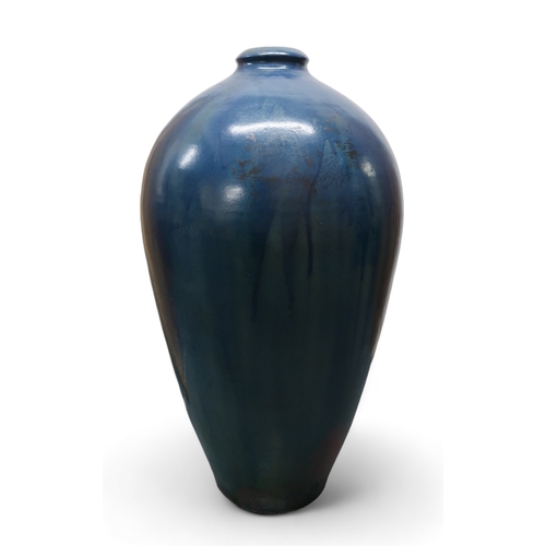 2323 - ALICE MACFARLANEAn oversized studio pottery vase of shouldered tapering form, in blue glaze, 95cm hi... 