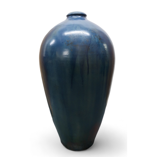 2323 - ALICE MACFARLANEAn oversized studio pottery vase of shouldered tapering form, in blue glaze, 95cm hi... 