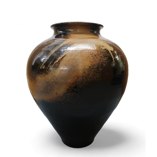 2322 - ALICE MACFARLANEAn oversized studio pottery vase of bulbous tapering form, in brown and tan glaze, 8... 