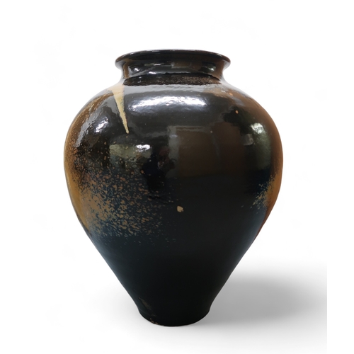 2322 - ALICE MACFARLANEAn oversized studio pottery vase of bulbous tapering form, in brown and tan glaze, 8... 