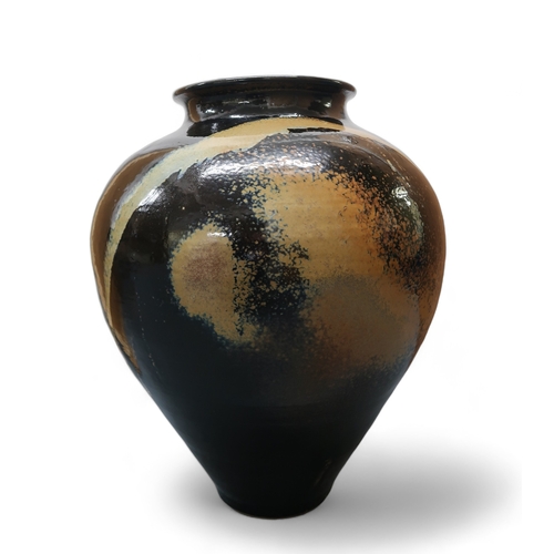 2322 - ALICE MACFARLANEAn oversized studio pottery vase of bulbous tapering form, in brown and tan glaze, 8... 