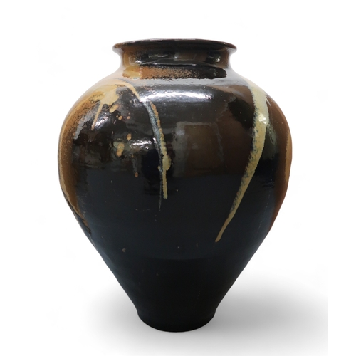 2322 - ALICE MACFARLANEAn oversized studio pottery vase of bulbous tapering form, in brown and tan glaze, 8... 