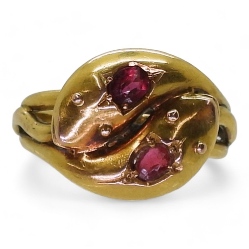 2775 - A SNAKE RINGthe double heads are set with a ruby and a red gem, Chester hallmarks for 1915, made by ... 