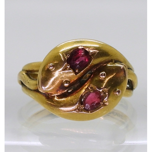 2775 - A SNAKE RINGthe double heads are set with a ruby and a red gem, Chester hallmarks for 1915, made by ... 