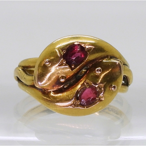 2775 - A SNAKE RINGthe double heads are set with a ruby and a red gem, Chester hallmarks for 1915, made by ... 