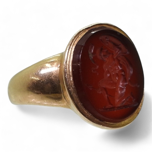 2776 - A GLADIATOR INTAGLIO RINGthe carved carnelian, is set in a yellow metal ring, the inner shank inscri... 