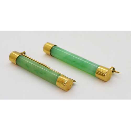 2782 - TWO CHINESE BROOCHESboth with bright yellow metal mounts and set with Chinese green hardstone, one m... 