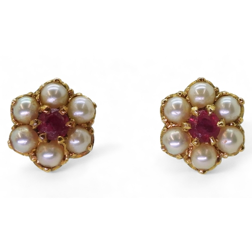 2784 - RUBY AND PEARL EARRINGSset in 18ct gold scroll mounts, with secure screw post fittings. diameter of ... 