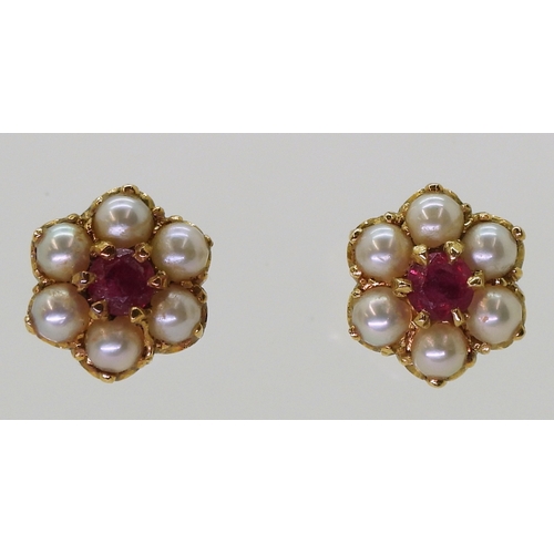 2784 - RUBY AND PEARL EARRINGSset in 18ct gold scroll mounts, with secure screw post fittings. diameter of ... 