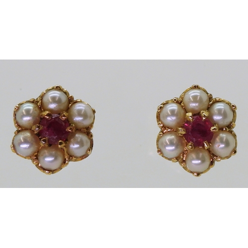 2784 - RUBY AND PEARL EARRINGSset in 18ct gold scroll mounts, with secure screw post fittings. diameter of ... 