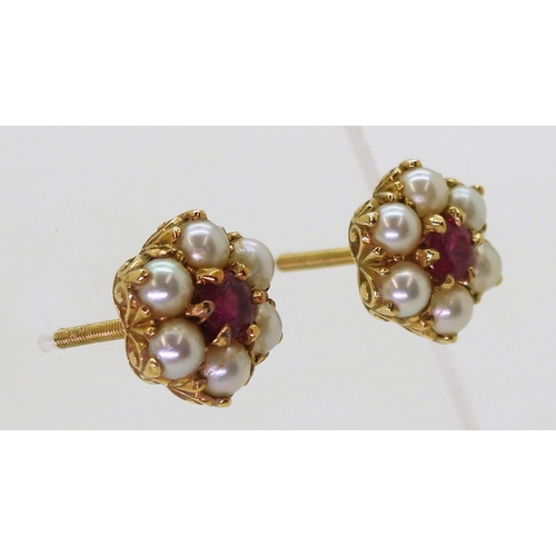 2784 - RUBY AND PEARL EARRINGSset in 18ct gold scroll mounts, with secure screw post fittings. diameter of ... 