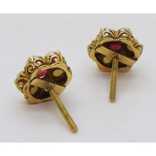 2784 - RUBY AND PEARL EARRINGSset in 18ct gold scroll mounts, with secure screw post fittings. diameter of ... 