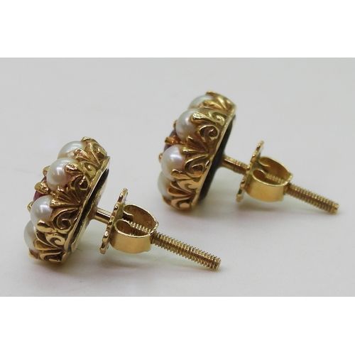 2784 - RUBY AND PEARL EARRINGSset in 18ct gold scroll mounts, with secure screw post fittings. diameter of ... 