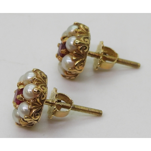 2784 - RUBY AND PEARL EARRINGSset in 18ct gold scroll mounts, with secure screw post fittings. diameter of ... 