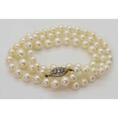 2786 - PEARLS WITH A DIAMOND CLASPthe clasp is in yellow and white metal and set with old cut diamonds with... 