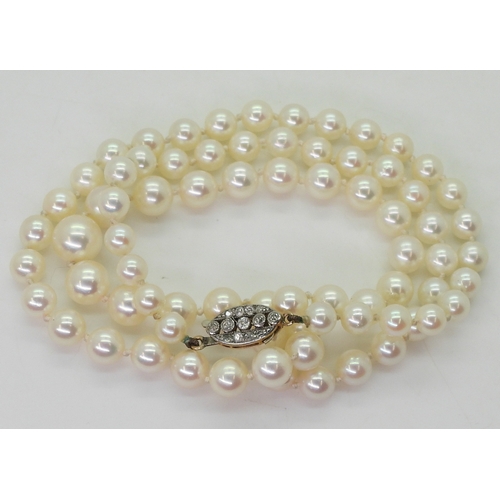 2786 - PEARLS WITH A DIAMOND CLASPthe clasp is in yellow and white metal and set with old cut diamonds with... 