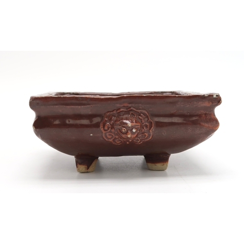 2404 - A CHINESE AUBERGINE GLAZED SQUARE CENSERThe shoulder applied with a pair of animal mask handles, abo... 