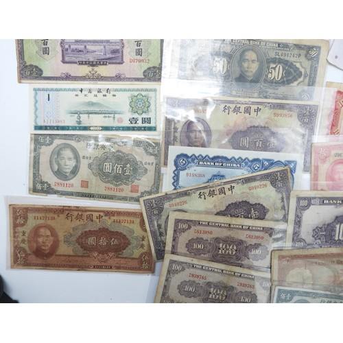 382 - A lot comprising Chinese bank notes Bank of China, Bank of Communications over stamped Shanghai, Cen... 