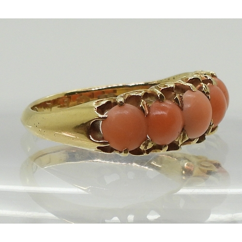 2787 - AN 18CT CORAL RINGwith Glasgow hallmarks for 1883, set with five corals to the classic scroll mount.... 