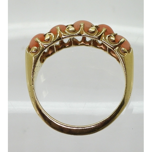 2787 - AN 18CT CORAL RINGwith Glasgow hallmarks for 1883, set with five corals to the classic scroll mount.... 