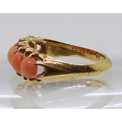 2787 - AN 18CT CORAL RINGwith Glasgow hallmarks for 1883, set with five corals to the classic scroll mount.... 