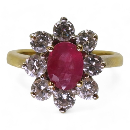 2788 - AN 18CT GOLD RUBY & DIAMOND RINGset with an 7.9mm x 5.9mm x 2.9mm, oval cut ruby, surrounded wit... 