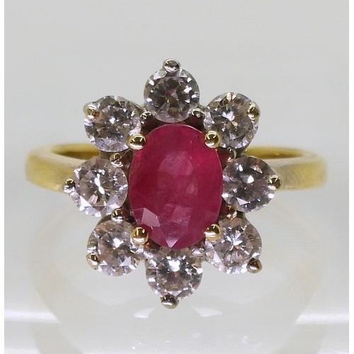 2788 - AN 18CT GOLD RUBY & DIAMOND RINGset with an 7.9mm x 5.9mm x 2.9mm, oval cut ruby, surrounded wit... 