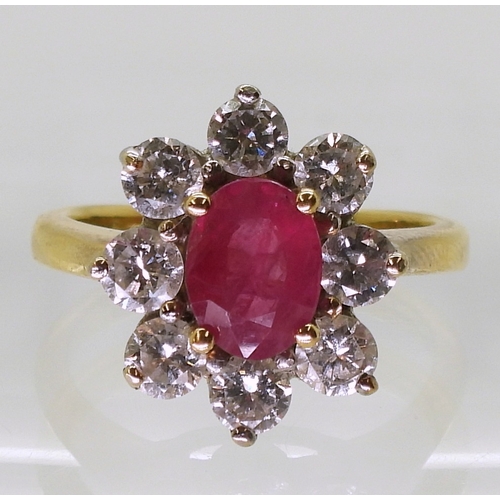 2788 - AN 18CT GOLD RUBY & DIAMOND RINGset with an 7.9mm x 5.9mm x 2.9mm, oval cut ruby, surrounded wit... 