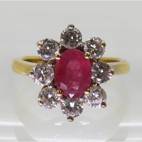 2788 - AN 18CT GOLD RUBY & DIAMOND RINGset with an 7.9mm x 5.9mm x 2.9mm, oval cut ruby, surrounded wit... 