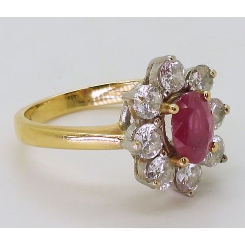 2788 - AN 18CT GOLD RUBY & DIAMOND RINGset with an 7.9mm x 5.9mm x 2.9mm, oval cut ruby, surrounded wit... 