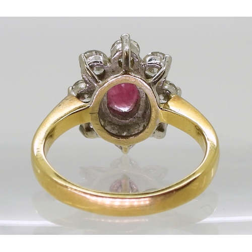 2788 - AN 18CT GOLD RUBY & DIAMOND RINGset with an 7.9mm x 5.9mm x 2.9mm, oval cut ruby, surrounded wit... 