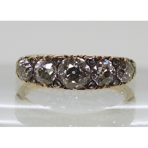 2792 - A FIVE STONE DIAMOND RINGthe five diamond are set in a classic scroll mount, with an estimated appro... 