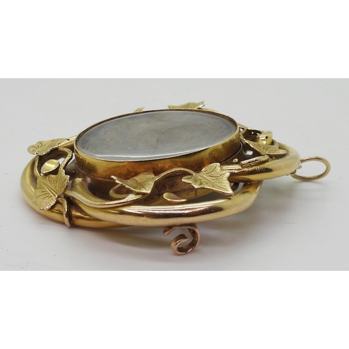 2794 - AN IVY LEAF MOURNING PENDANT/BROOCHmade in bright yellow metal, with two locket compartments filled ... 