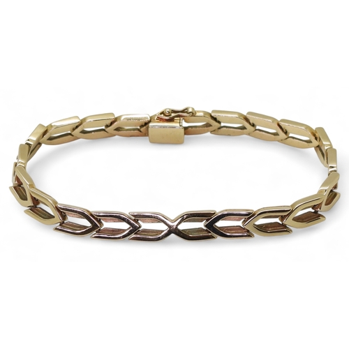 2798 - A 9CT GOLD ERIC SMITH BRACELETof chevron links, retailed by Cairncross of Perth. Length 18.5cm, weig... 