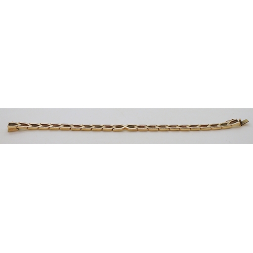 2798 - A 9CT GOLD ERIC SMITH BRACELETof chevron links, retailed by Cairncross of Perth. Length 18.5cm, weig... 