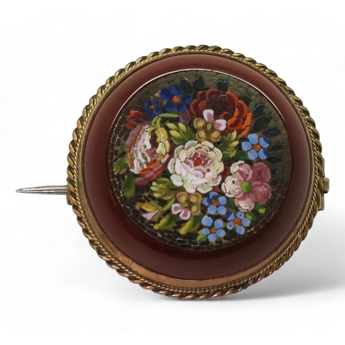 2804 - A MICRO MOSAIC BROOCHdepicting flowers set into a carved carnelian rondel. With a yellow metal mount... 