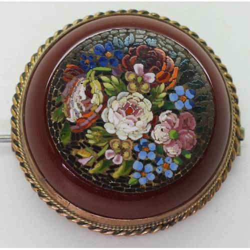 2804 - A MICRO MOSAIC BROOCHdepicting flowers set into a carved carnelian rondel. With a yellow metal mount... 